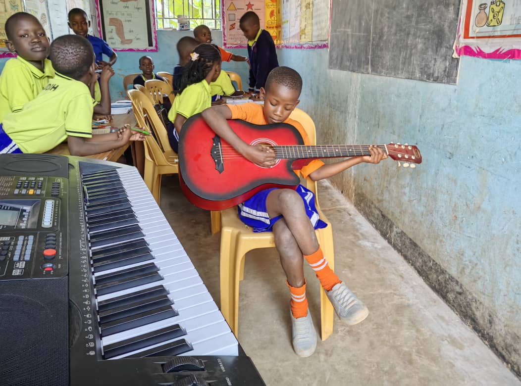 Children learning musical instruments